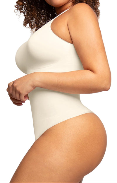 Person wearing a white bodysuit on a plain background